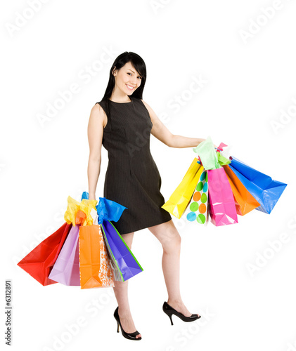 An isolated shot of a beautiful woman carrying shopping bags