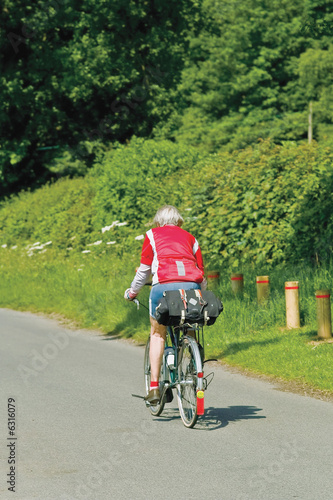 A group of senior cyclists cycling along road warwickshire