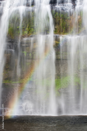 Tropical waterfall with colorful rainbow in Brazil