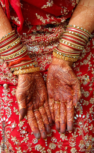 hands of an indian bride decorated with henna