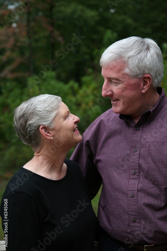 Happy Senior Couple smiling outside