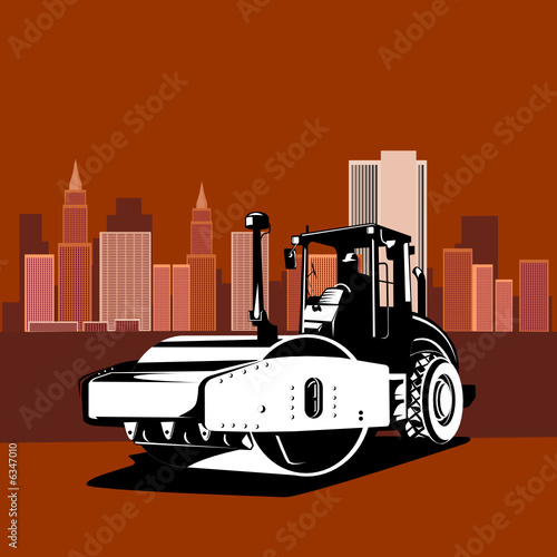Road compactor with building in the background
