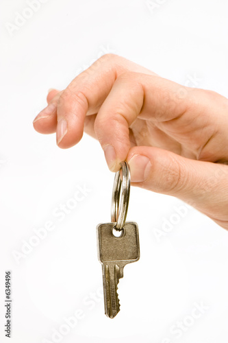 close up of a person's hand, handing over a key.  