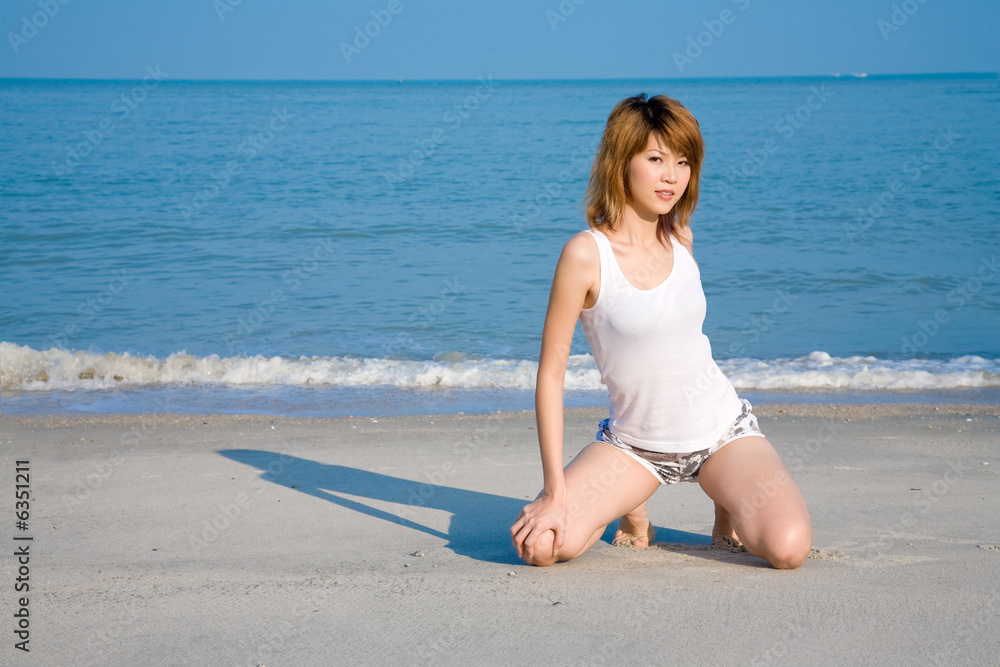 woman sesually kneeling on the beach