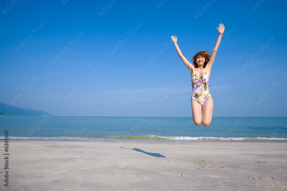 woman jumping and having fun by the beach woman jumping and having fun by the beach