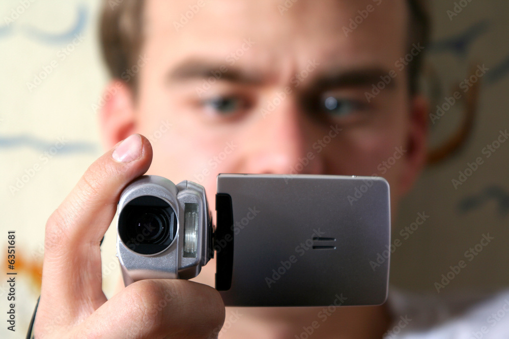Fototapeta premium young man with digital video camera