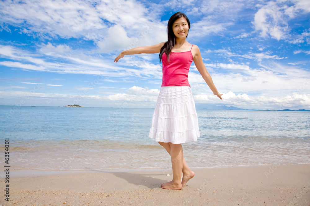 beautiful girl in red top& white skirt stretching on a beach beautiful girl in red top& white skirt stretching on a beach