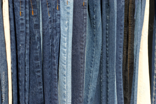 row of different color blue jeans © snoopdoug