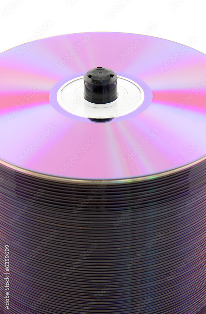 Purple CDs or DVDs on spindle, on white background. No dust. Purple CDs or DVDs on spindle, on white background. No dust.