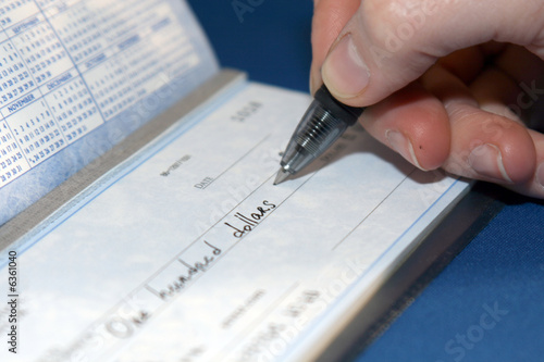 Closeup of a person writing a big check
