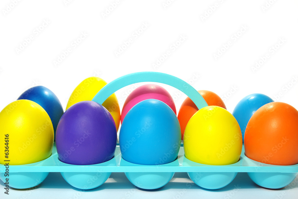 Easter holiday. Color eggs in a tray on white background. Easter holiday. Color eggs in a tray on white background.