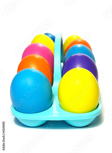 Easter holiday. Color eggs in a tray on white  background. photo