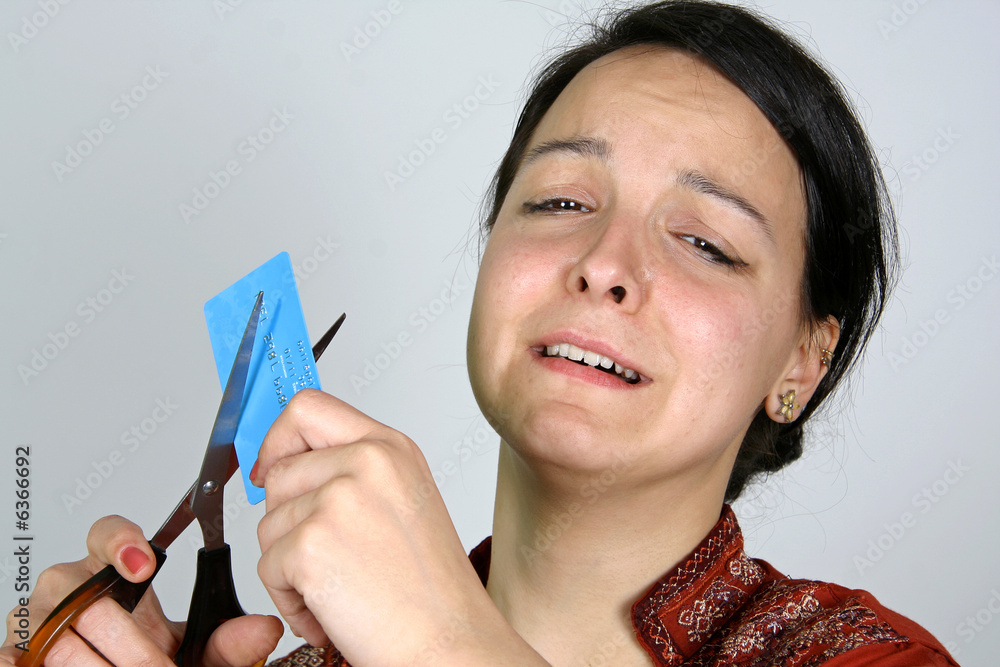 lady cutting up credit card in despair Stock Photo Adobe Stock