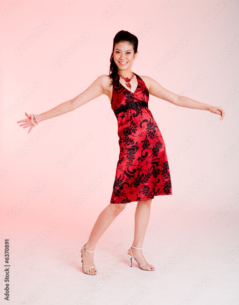 girl in a red floral dress expressing joy girl in a red floral dress expressing joy