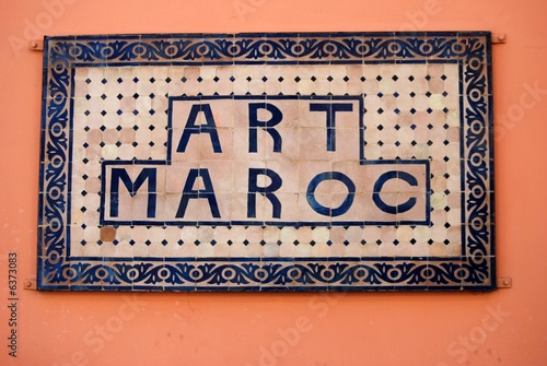 old sign-board on the orange back-ground of wall