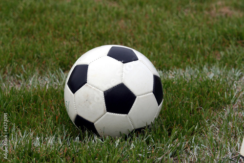 A soccer ball sits on a field © Rob