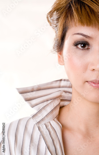 half face of a asian business woman with collar up