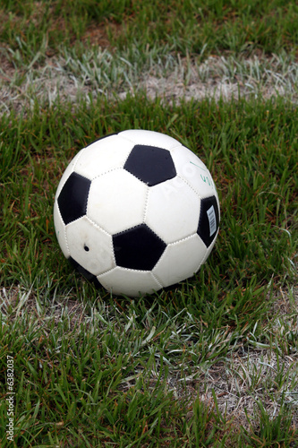 A soccer ball sits on a field © Rob