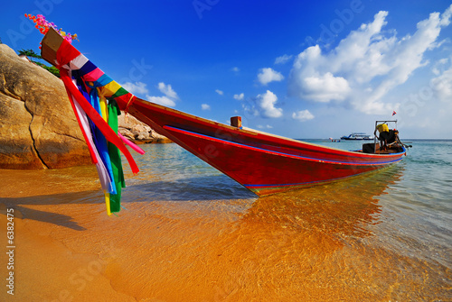 Traditional Thai Longtail boat on the beach photo
