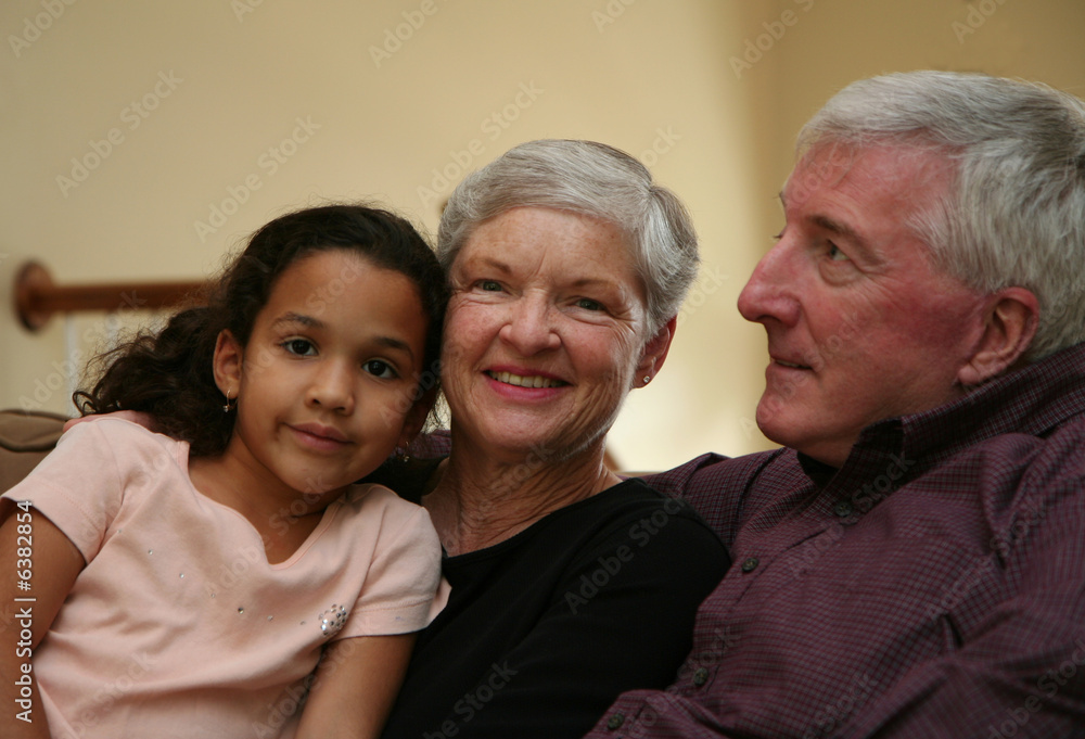 Happy Senior Couple smiling with grandchild