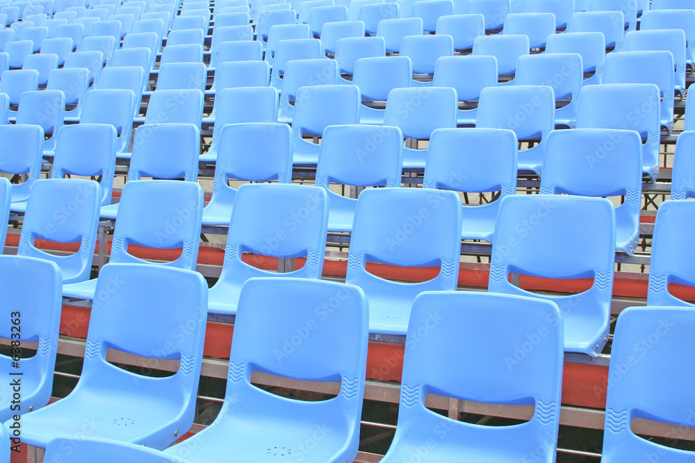 Fototapeta premium Empty blue bleachers in an open air environment