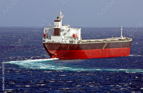 Cargo ship balk carrier maks turn on the sea surface