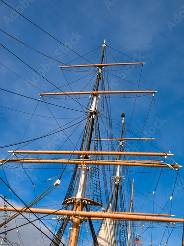 Three masts and tackle of a tallship against blue sky