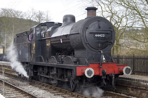 A steam engine pulls into the station