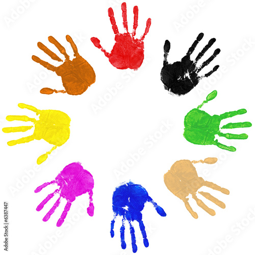 Multi coloured painted handprints arranged in a circle on white