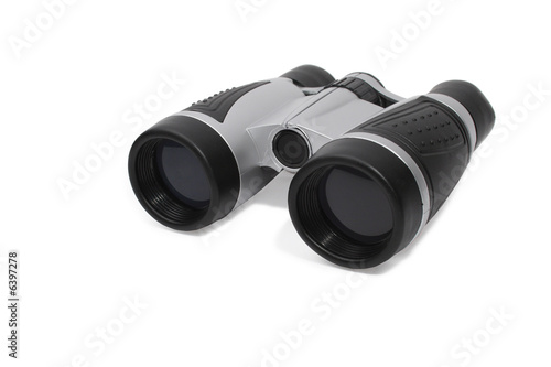 Modern binoculars lying on white background