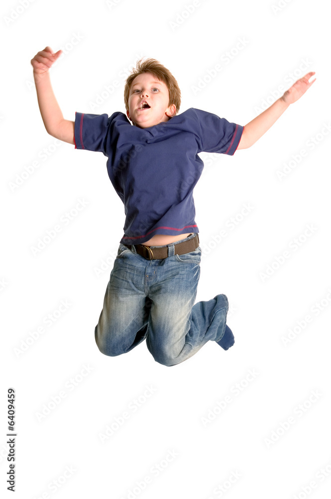 Young boy jumping in the air, isolated on white, motion blur.