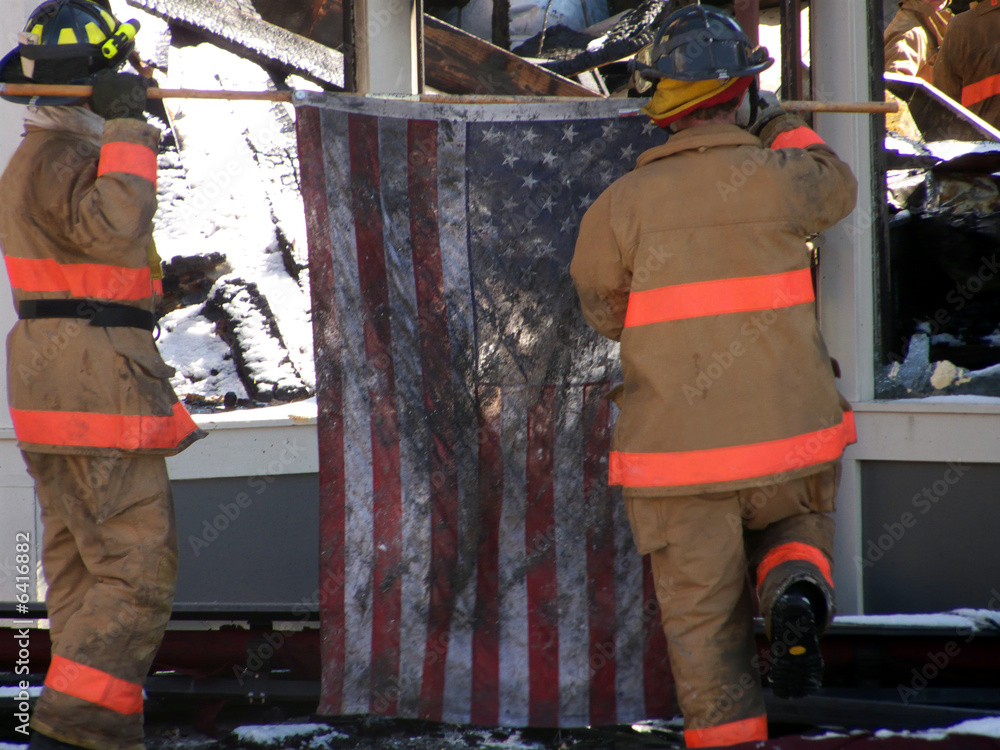 Firemen raising the American Flag after heroic firefight Firemen raising the American Flag after heroic firefight