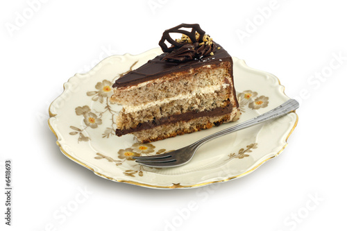 Chocolate cake with nuts on old, stylish plate