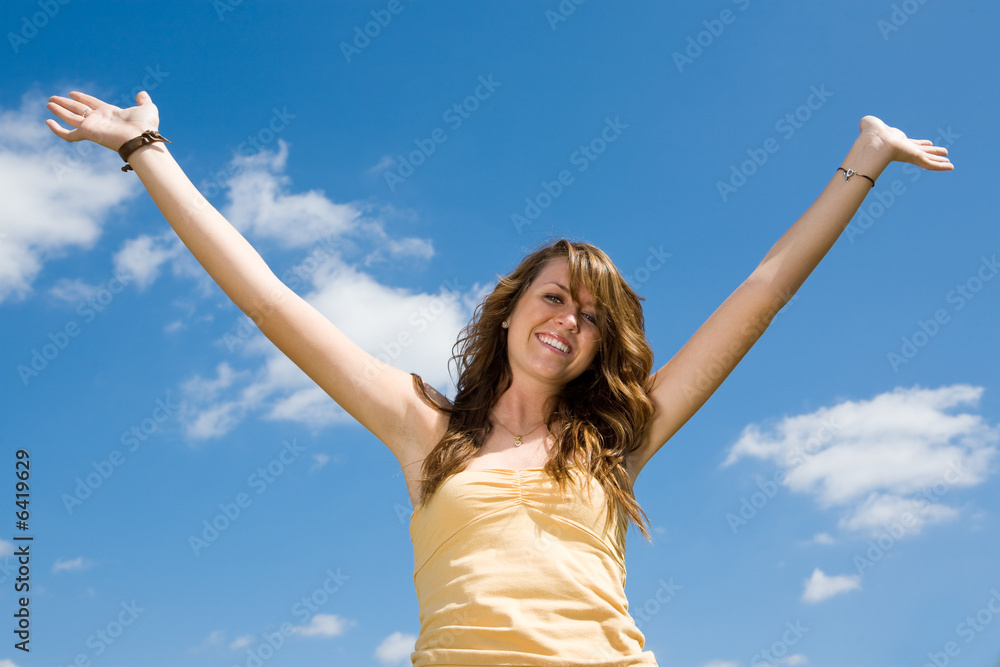 Beautiful teen girl raising her hands in joy and praise Beautiful teen girl raising her hands in joy and praise