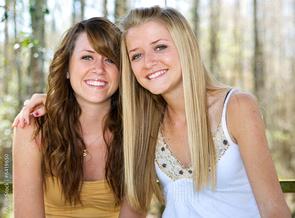 Portrait of beautiful teen sisters in natural setting. 
