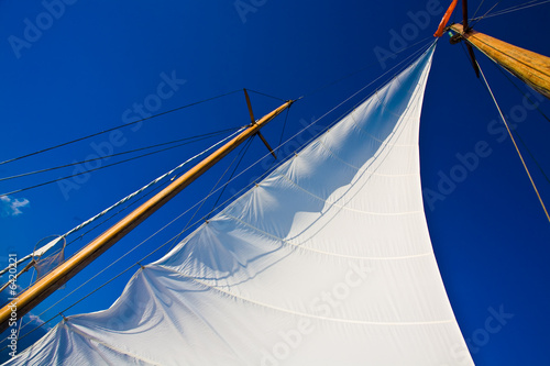Photo Yacht sail and blue cloudless aky above