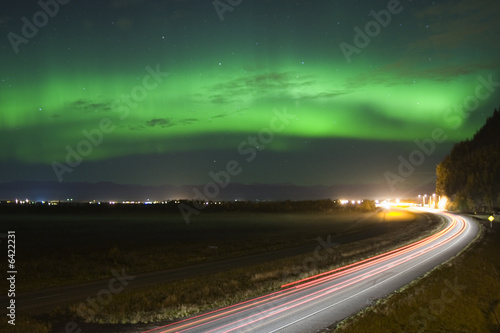 Aurora Boreali over night highwayin Alaska
