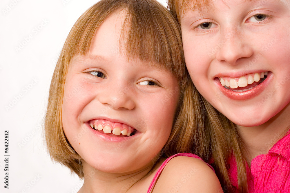Two girls joyful smiling isolated over white Two girls joyful smiling isolated over white