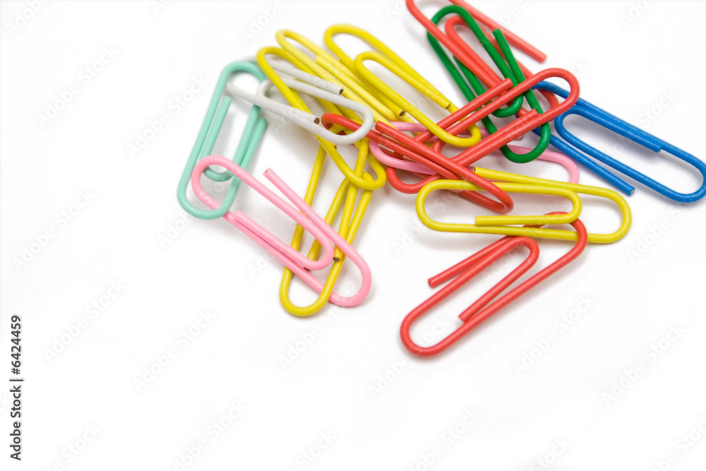 multicolored paper-clip on the white isolated background multicolored paper-clip on the white isolated background
