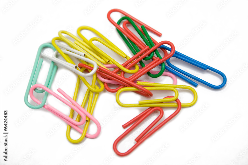 multicolored paper-clip on the white isolated background multicolored paper-clip on the white isolated background