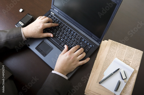 Businessman working on laptop.