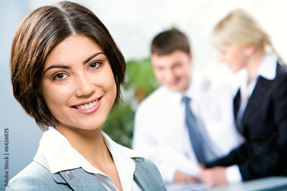 Face of beautiful woman on background of business people Face of beautiful woman on background of business people
