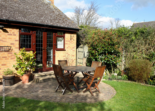 Springtime  in an English Garden with patio table and chairs