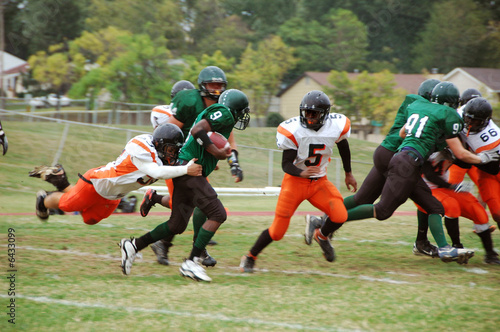 Running back american football player being tacked © Carlos Santa Maria