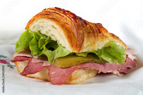 croissant sandwich with Corned Beef and ham