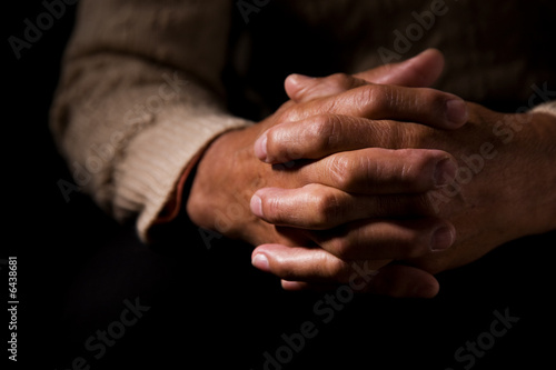 A shot of hands of an old man praying