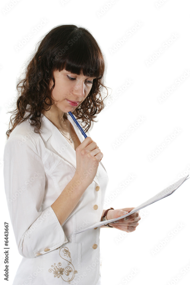 The beautiful young woman writes in documents The beautiful young woman writes in documents