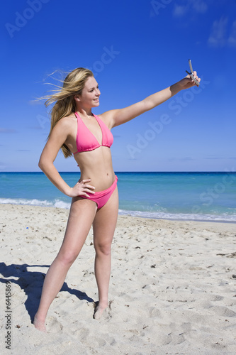 Beautiful Caucasian female teenage standing on the beach