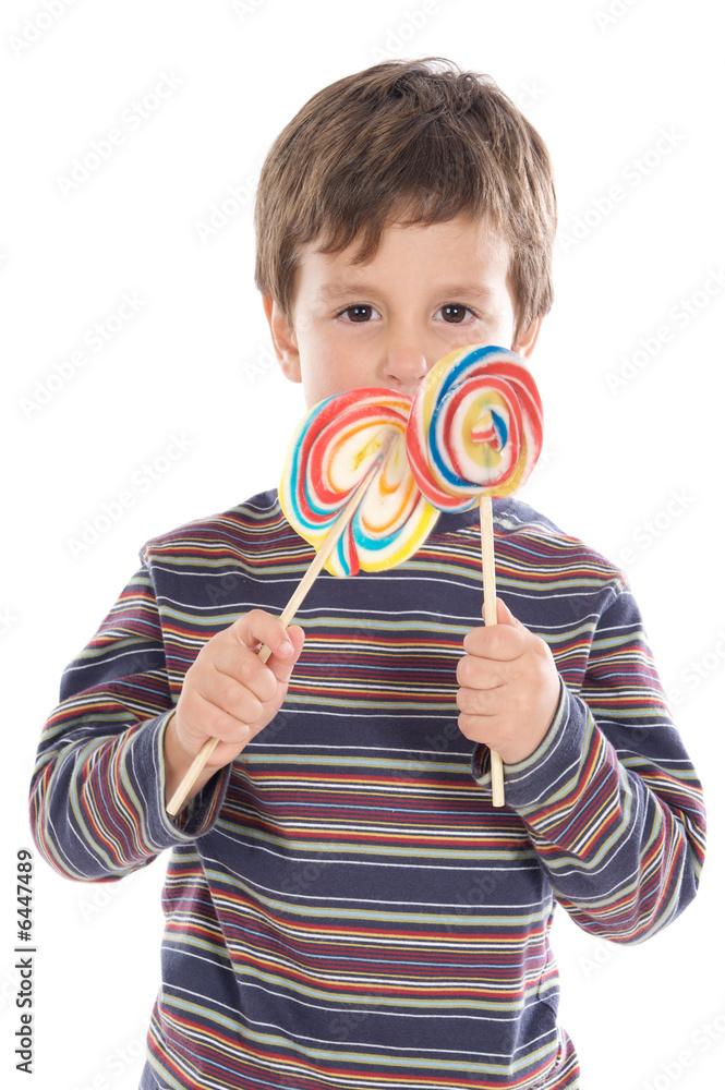 Adorable child eating two lollipops a over white background