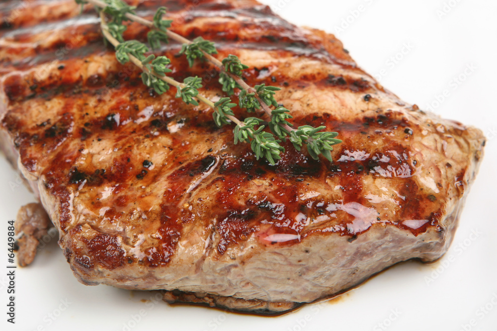 Sirloin steak resting on a white plate Sirloin steak resting on a white plate